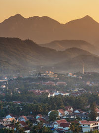 High angle view of townscape and mountains against sky