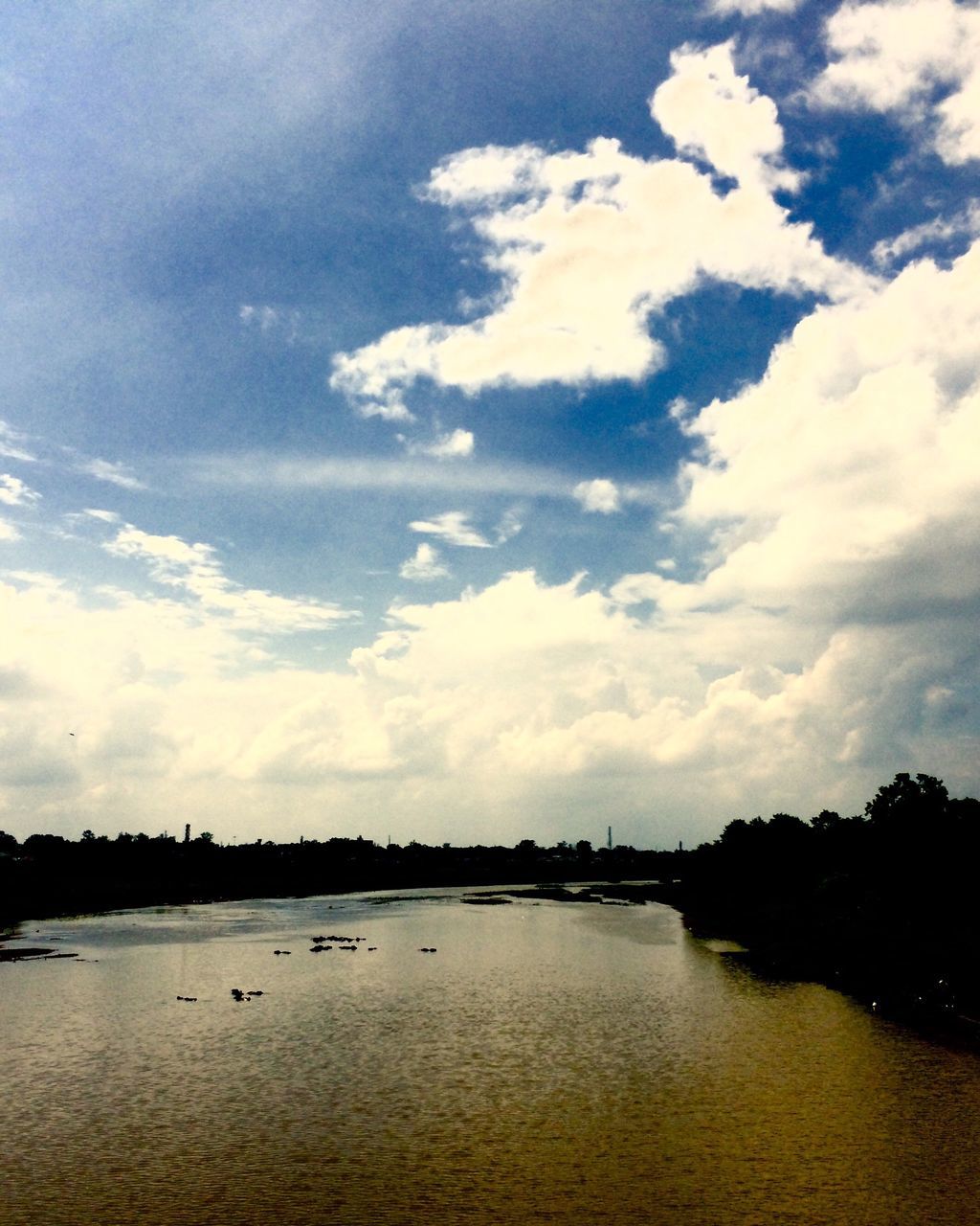 water, tranquil scene, tranquility, calm, scenics, lake, beauty in nature, sky, majestic, cloud, nature, idyllic, waterfront, non-urban scene, cloud - sky, reflection, river, tourism, day, cloudscape, no people, outdoors, countryside, vacations, cloudy, ocean, dramatic sky