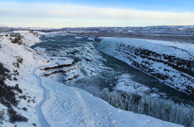 Scenic view of snowcapped mountains against sky, gullfoss waterfall in iceland, europe