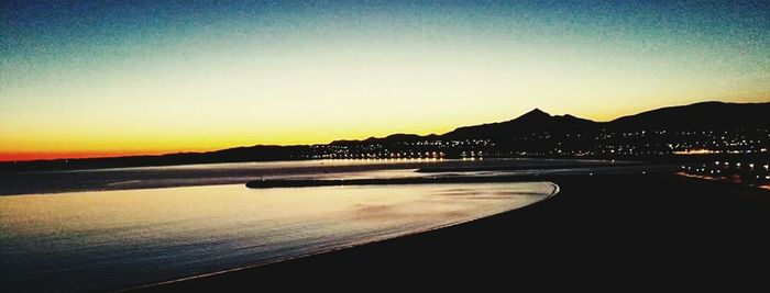 Scenic view of beach against sky during sunset