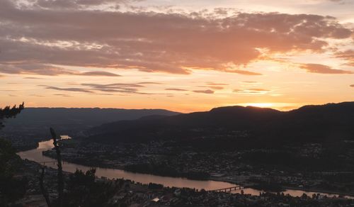High angle view of silhouette mountains against sky during sunset