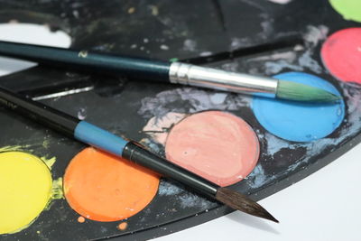 High angle view of paintbrushes in container