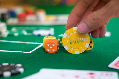Close-up of hand playing on table