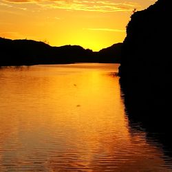 Scenic view of lake against romantic sky at sunset