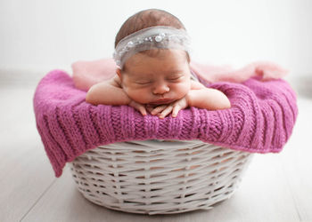 High angle view of cute baby boy in wicker basket