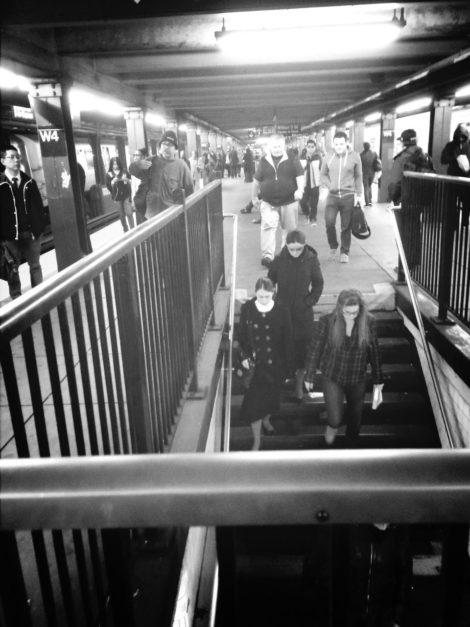 indoors, large group of people, person, men, lifestyles, leisure activity, illuminated, shopping mall, walking, crowd, medium group of people, escalator, sitting, city life, shopping, group of people, mixed age range, commuter, incidental people