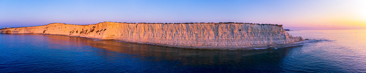 This wide pano shot with a drone is of munxar point, marsascala, malta summer 2021