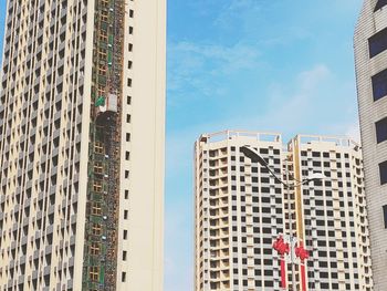 Low angle view of modern buildings in city against sky
