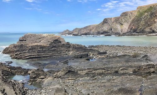 Scenic view of sea and mountains against sky
