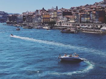 Scenic view of sea against buildings in city