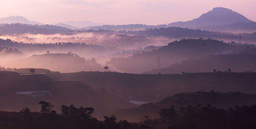 Scenic view of silhouette mountains against sky during sunset