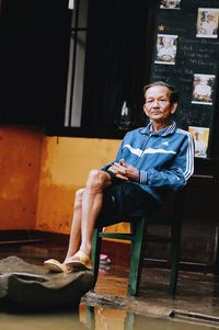 Portrait of mature man sitting in room