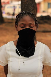 Close-up of woman wearing mask while standing outdoors