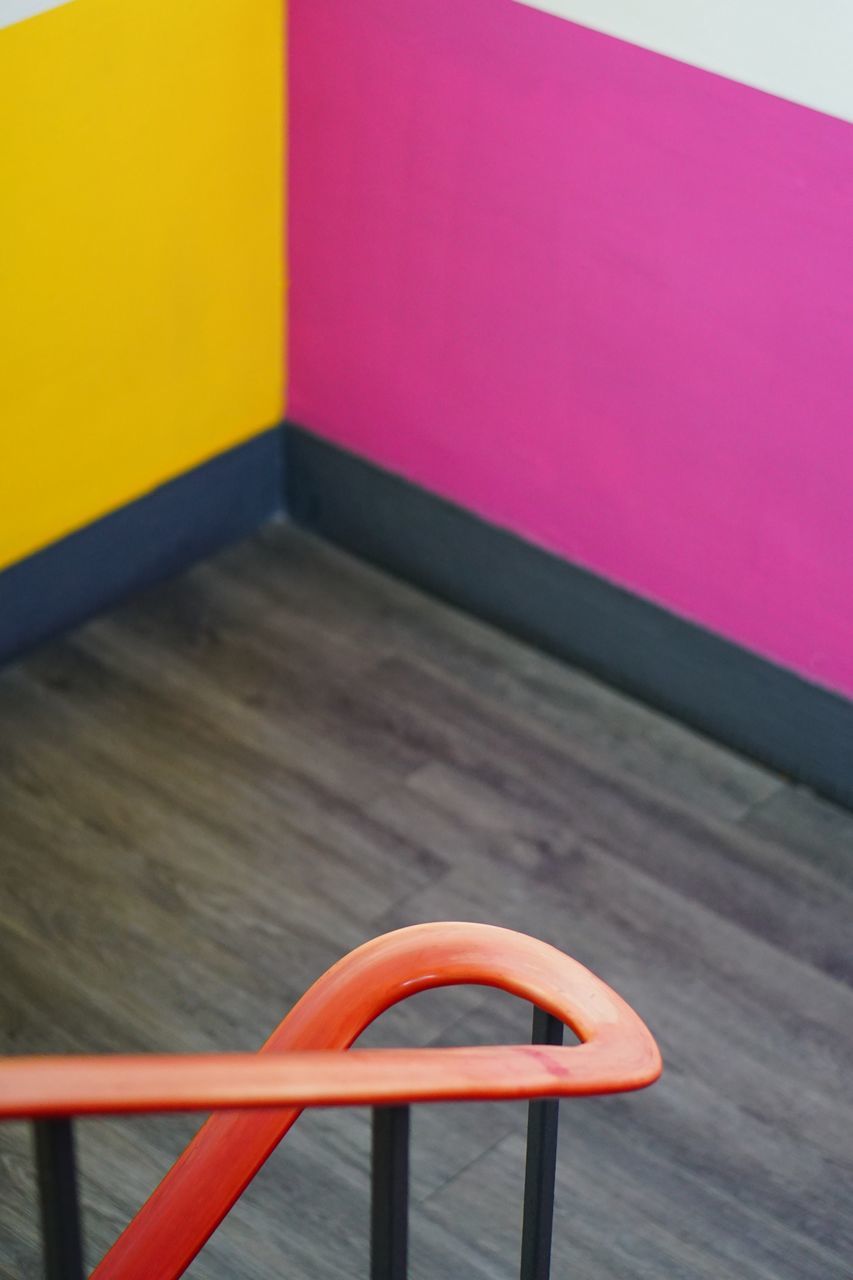 furniture, yellow, seat, no people, red, table, multi colored, indoors, chair, orange, wood, absence, architecture, pink, floor, flooring, vibrant color