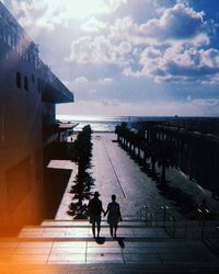People on sea against sky