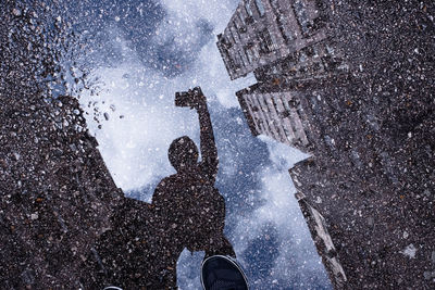 Low section of person standing on snow