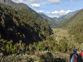 Rear view of people on mountain against sky