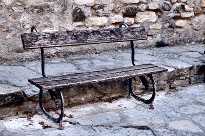 Close-up of chair against stone wall