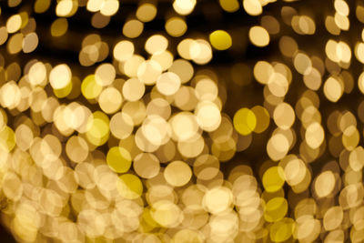 Glittering stars of bokeh. yellow shining sparkles for celebrate. black background