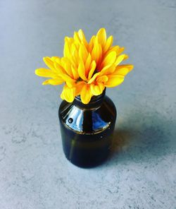 Close-up of yellow flower vase on table