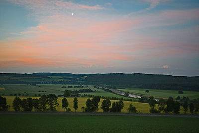 Scenic view of field against sky during sunset