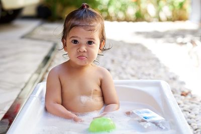 Portrait of cute baby girl in water