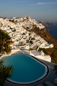 High angle view of townscape by sea against sky