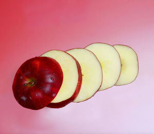 Close-up of apple against red background