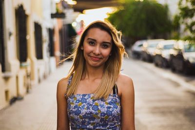 Portrait of smiling young woman standing outdoors