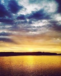 Scenic view of calm lake at sunset