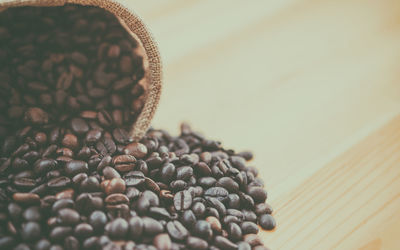 Close-up of roasted coffee beans on table