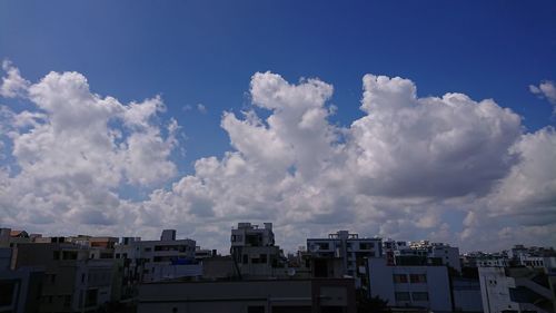 Panoramic view of cityscape against blue sky