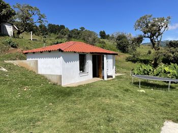 House on field against clear sky