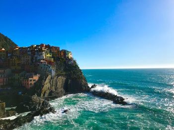 Scenic view of sea against clear blue sky