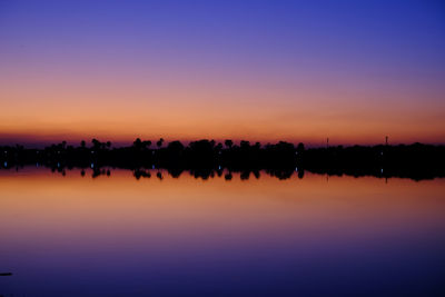 Scenic view of lake against romantic sky at sunset