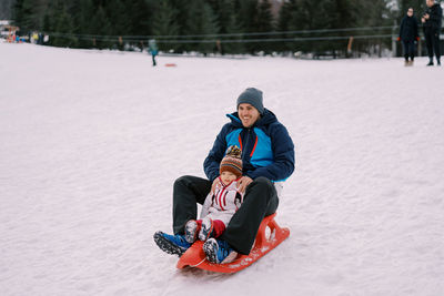 Man skiing on snow covered field