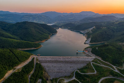 High angle view of river amidst mountains against sky river lake