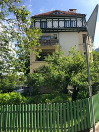 Low angle view of trees and building