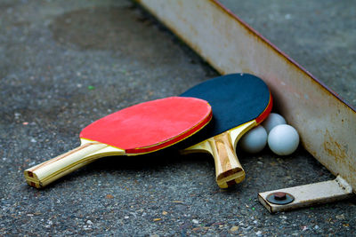 Table tennis bats left after a match with all balls ready for the next game.