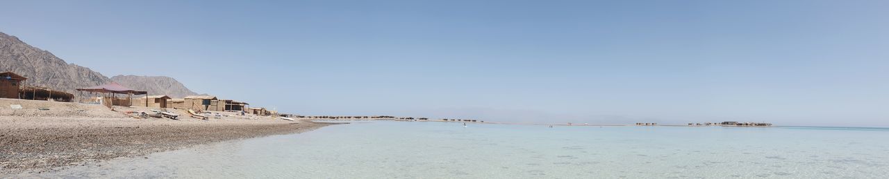 Panoramic view of beach against clear sky