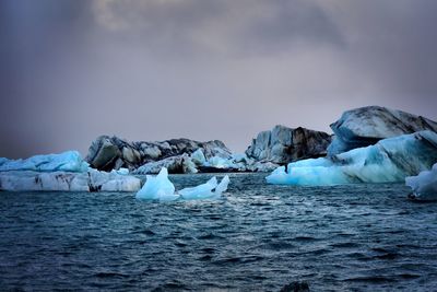 Scenic view of icebergs against sky