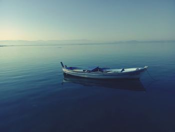 Boat moored in sea against sky