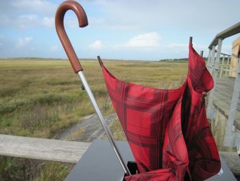 Close-up of red flag on field against sky