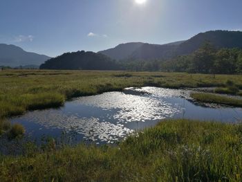 Scenic view of lake and mountains against sky