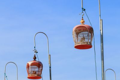 Low angle view of lanterns hanging against clear sky