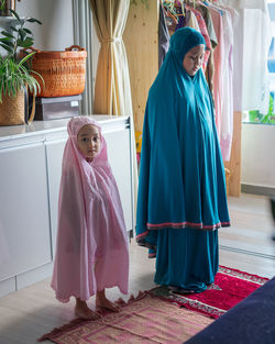 Muslim children praying at home. learning to pray for the little girl. happy and jovial child.