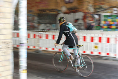 Full length of man with bicycle in city