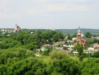 High angle view of trees and buildings against sky