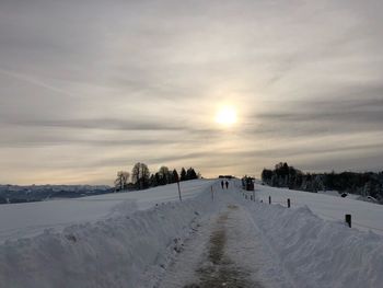 Scenic view of snow field against sky during sunset