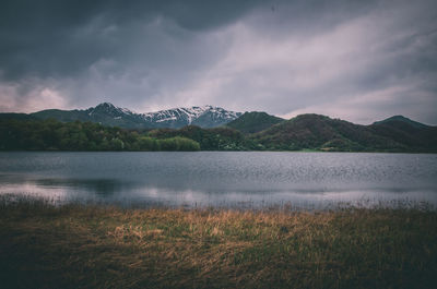 Scenic view of lake and mountains against sky